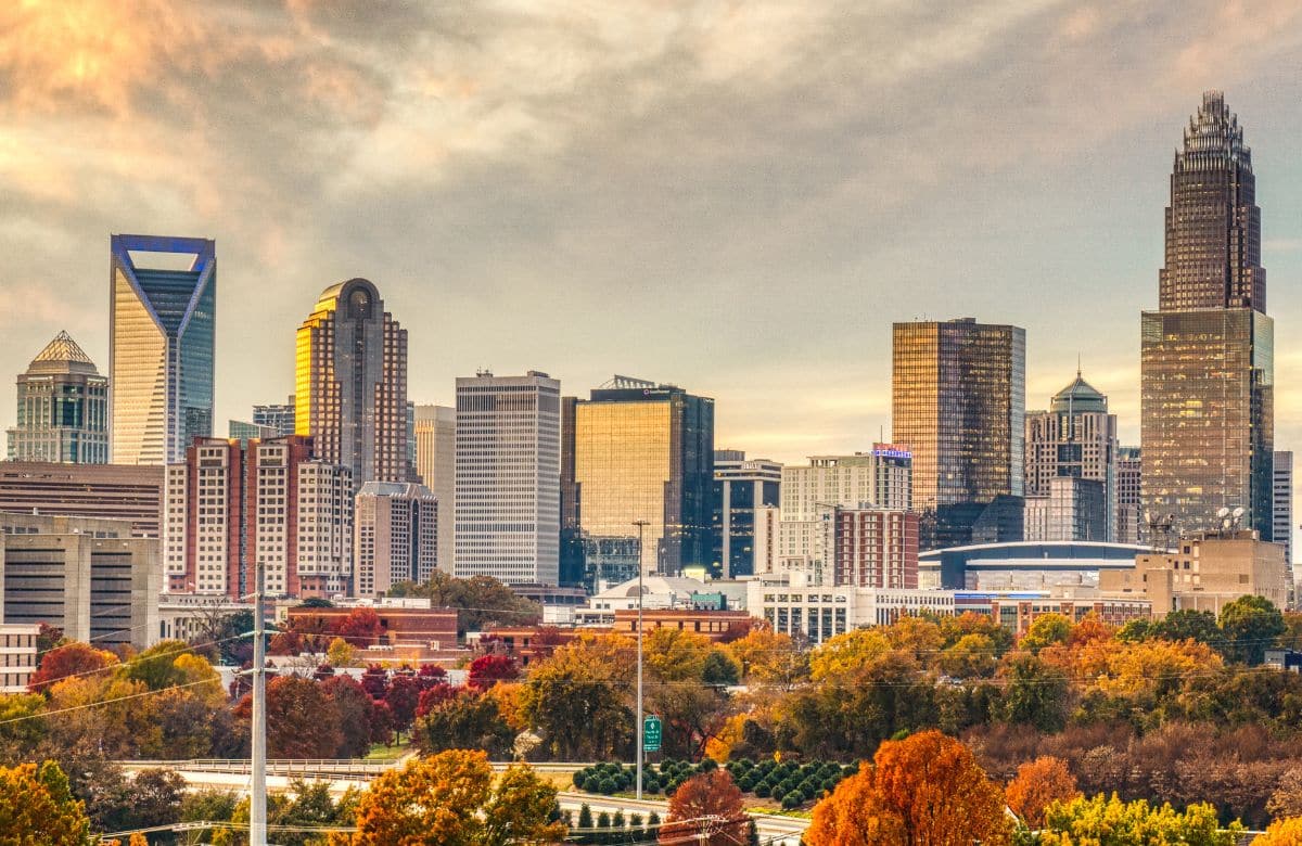 The Charlotte, North Carolina skyline at sunset with autumn trees in the foreground